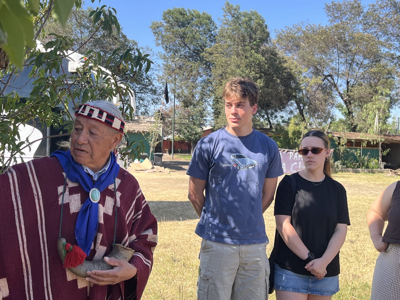 A student meeting a Mapuche elder in traditional dress